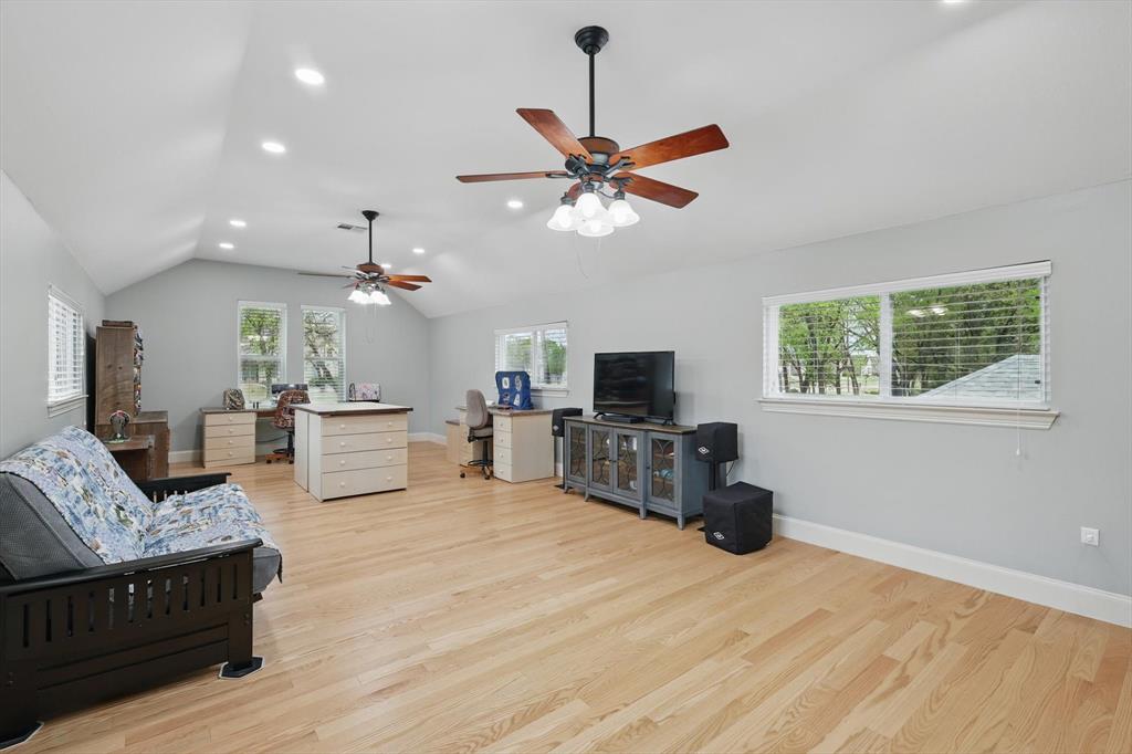 8517 Stallion Street Denton, TX 76208 - Photo 21 of 36 a living room with furniture and a flat screen tv