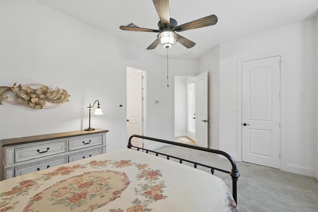 8517 Stallion Street Denton, TX 76208 - Photo 23 of 36 a bedroom with a bed and a dresser