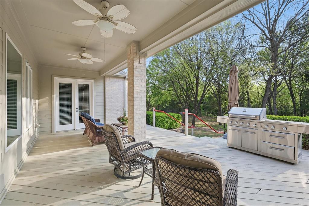 8517 Stallion Street Denton, TX 76208 - Photo 32 of 36 a view of a patio with a dining table and chairs
