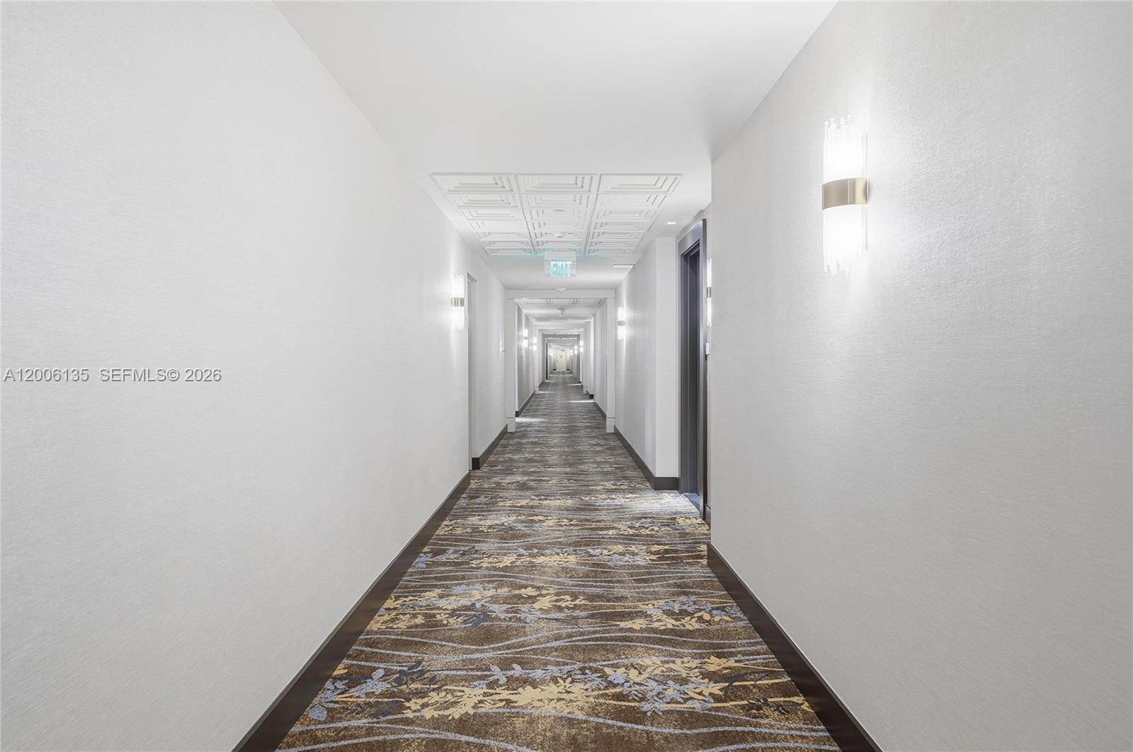 9801 Collins Avenue, Unit 14D Bal Harbour, FL 33154 - Photo 12 of 52 a view of a hallway with wooden floor and staircase