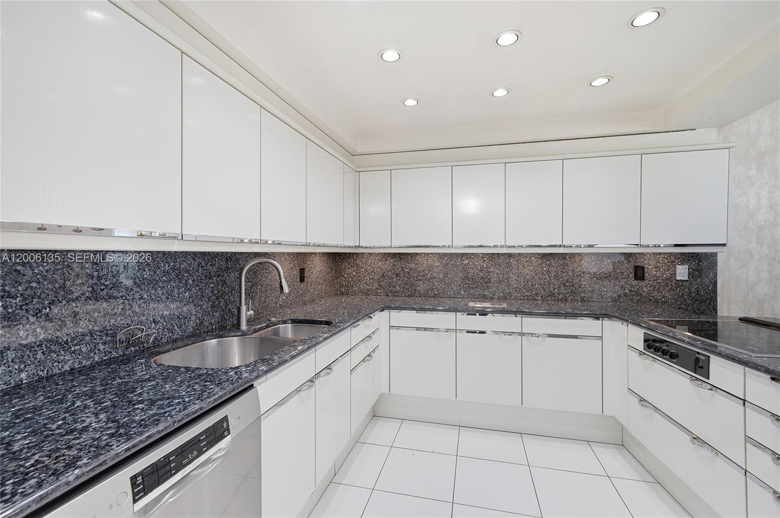 9801 Collins Avenue, Unit 14D Bal Harbour, FL 33154 - Photo 15 of 52 a kitchen with stainless steel appliances granite countertop a sink and cabinets
