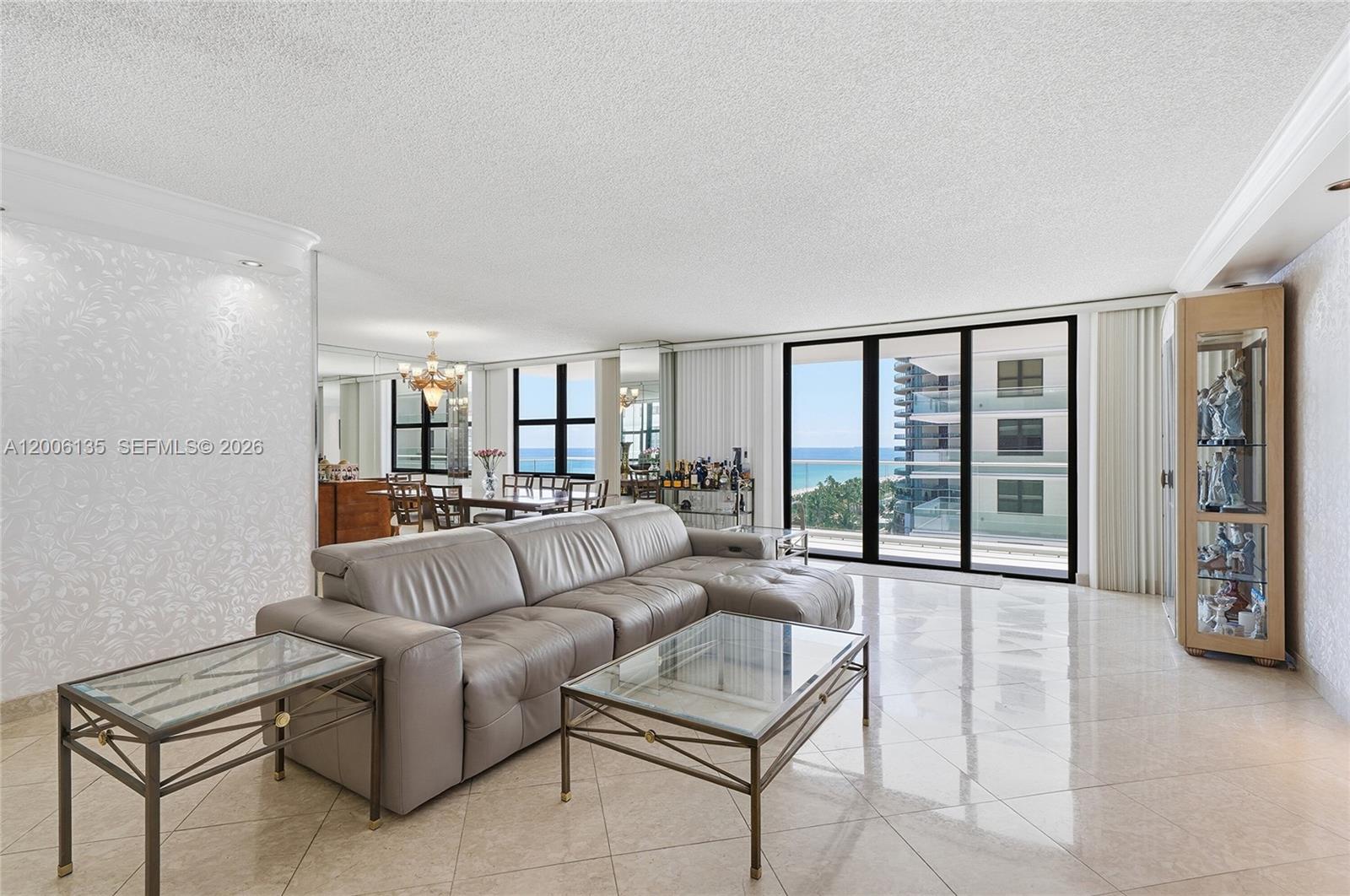 9801 Collins Avenue, Unit 14D Bal Harbour, FL 33154 - Photo 22 of 52 a living room with furniture and a large window