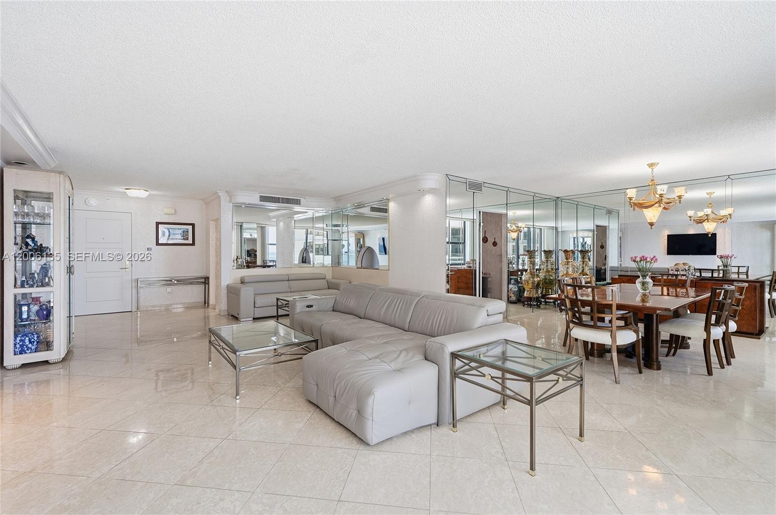 9801 Collins Avenue, Unit 14D Bal Harbour, FL 33154 - Photo 24 of 52 a living room with furniture and a table