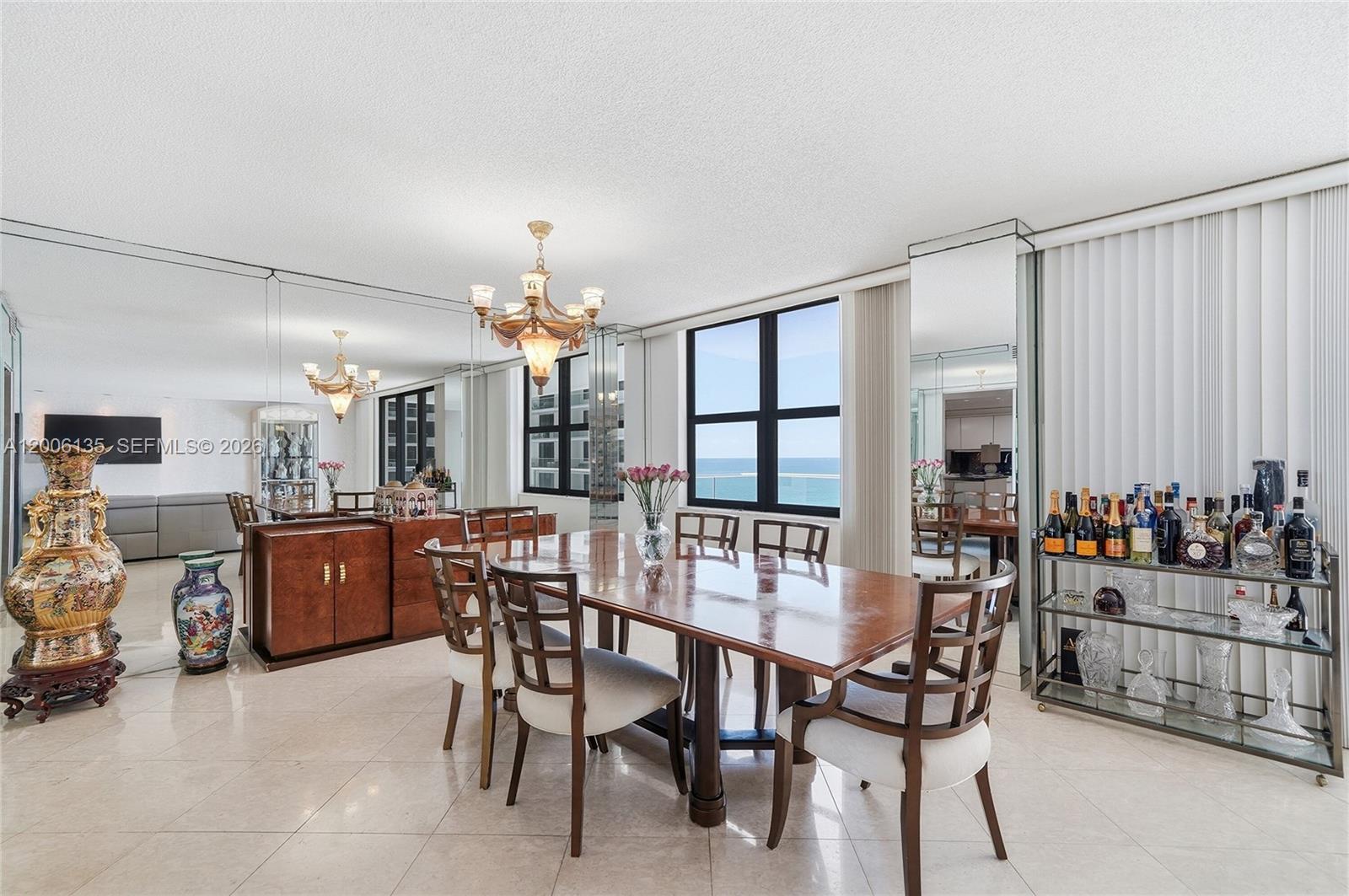9801 Collins Avenue, Unit 14D Bal Harbour, FL 33154 - Photo 26 of 52 a dining room with furniture and window