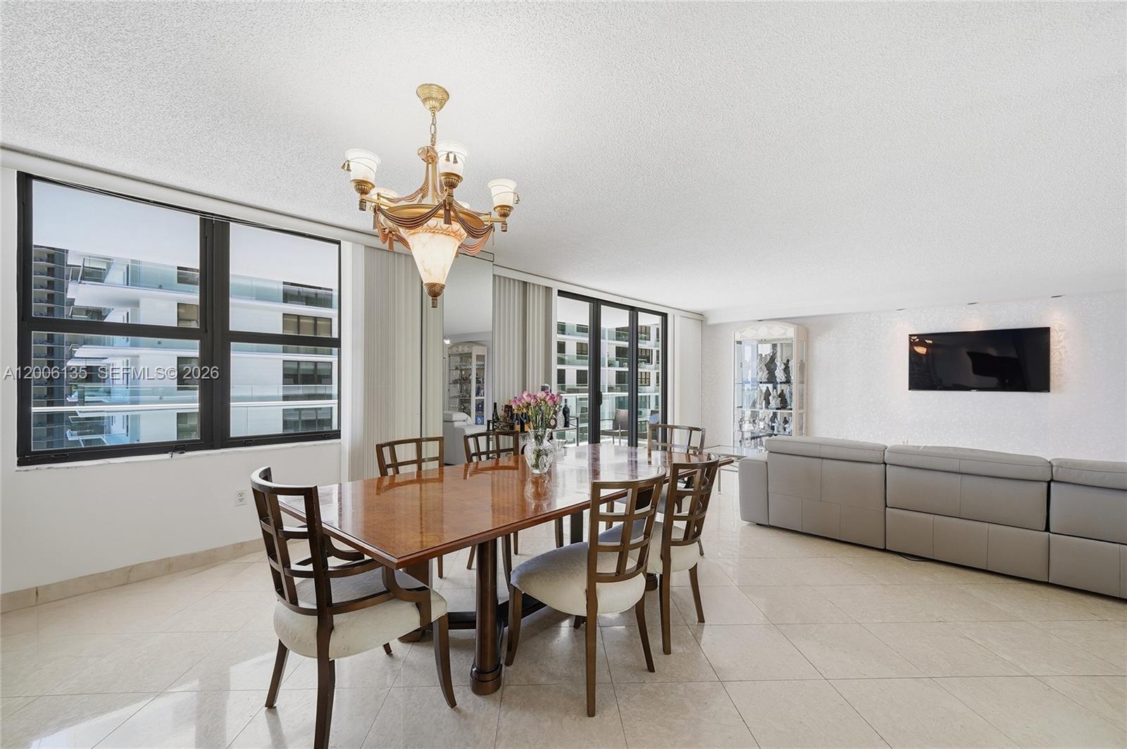 9801 Collins Avenue, Unit 14D Bal Harbour, FL 33154 - Photo 27 of 52 a dining room with furniture and window