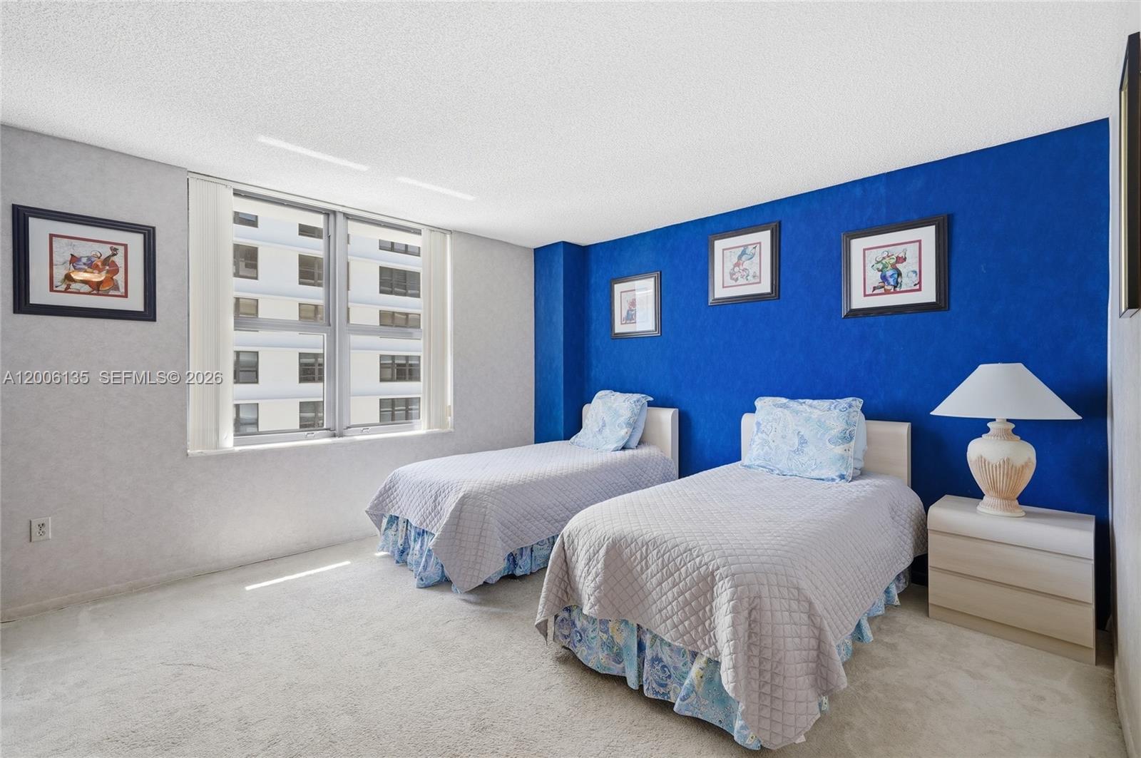 9801 Collins Avenue, Unit 14D Bal Harbour, FL 33154 - Photo 32 of 52 a bedroom with two beds and a window