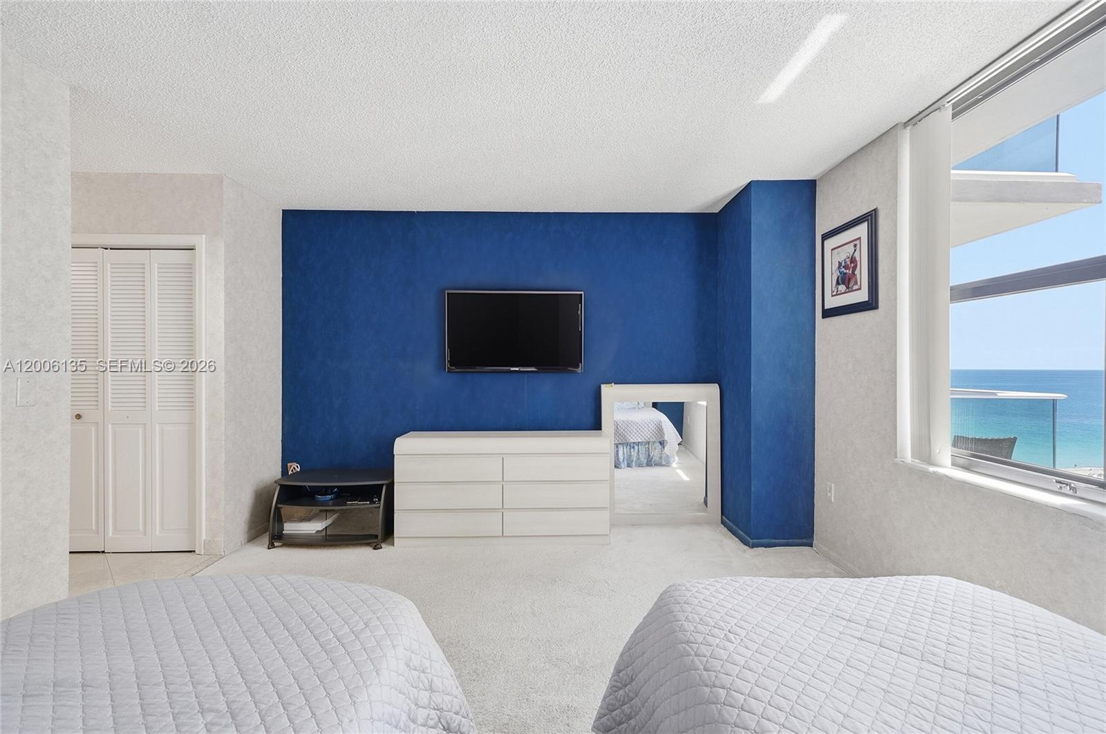 9801 Collins Avenue, Unit 14D Bal Harbour, FL 33154 - Photo 34 of 52 a bedroom with a bed and a flat screen tv
