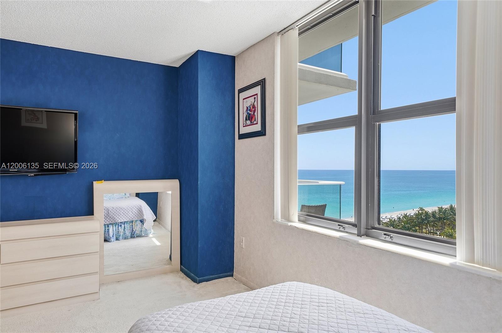 9801 Collins Avenue, Unit 14D Bal Harbour, FL 33154 - Photo 35 of 52 a bedroom with a bed and a flat screen tv