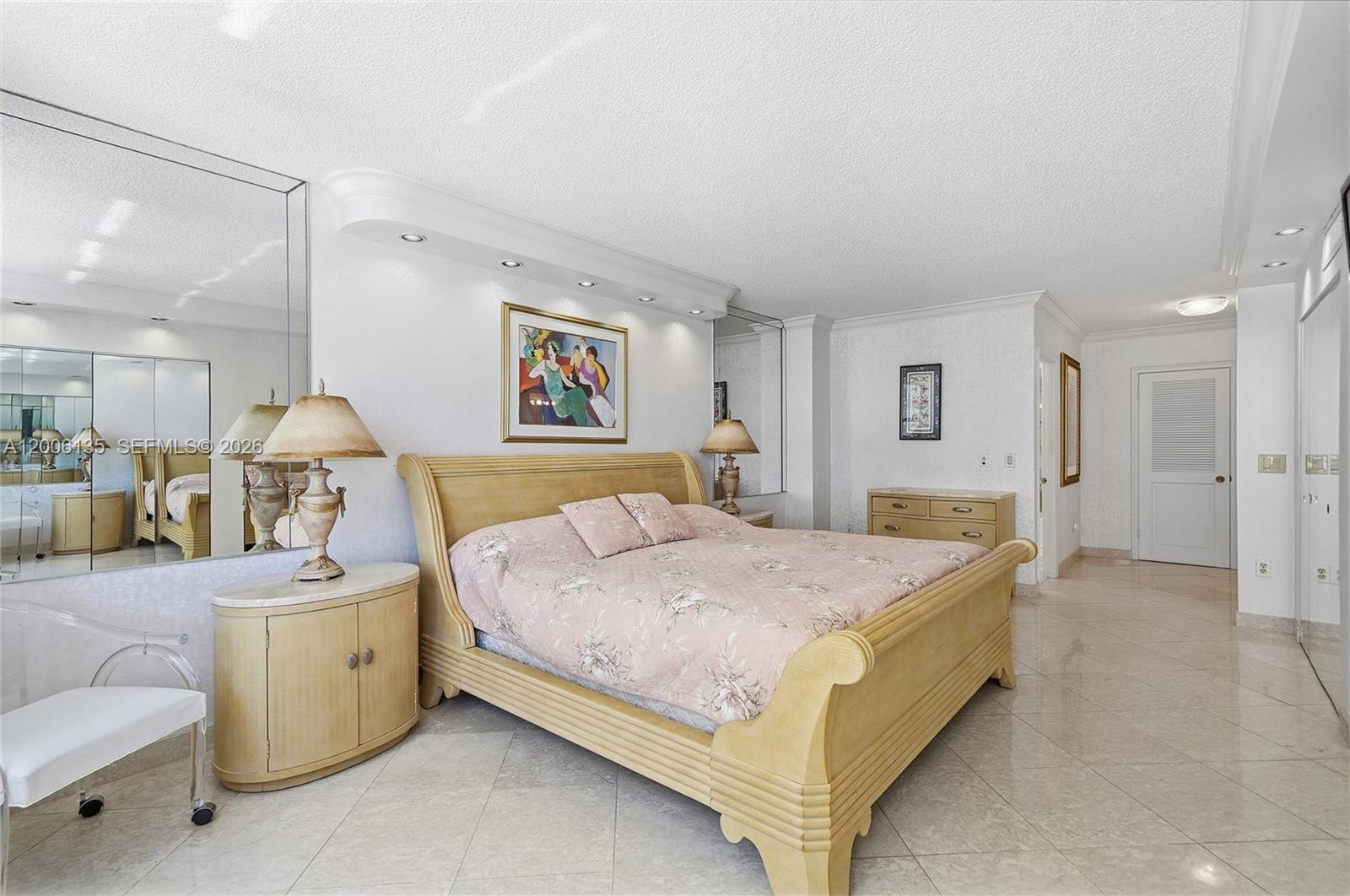 9801 Collins Avenue, Unit 14D Bal Harbour, FL 33154 - Photo 39 of 52 a spacious bedroom with a bed and a couch