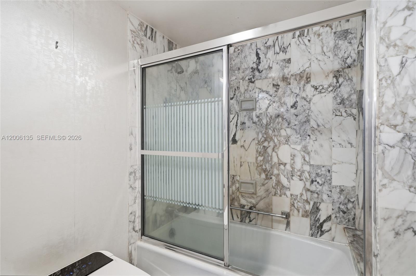 9801 Collins Avenue, Unit 14D Bal Harbour, FL 33154 - Photo 42 of 52 a bathroom with a shower
