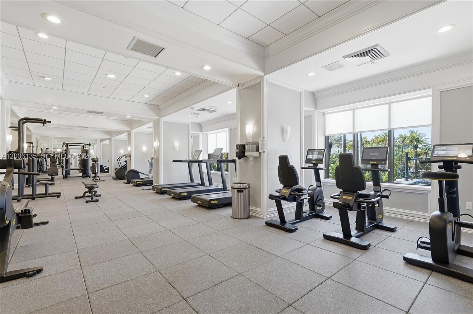 9801 Collins Avenue, Unit 14D Bal Harbour, FL 33154 - Photo 47 of 52 a view of a room with gym equipment and large mirror