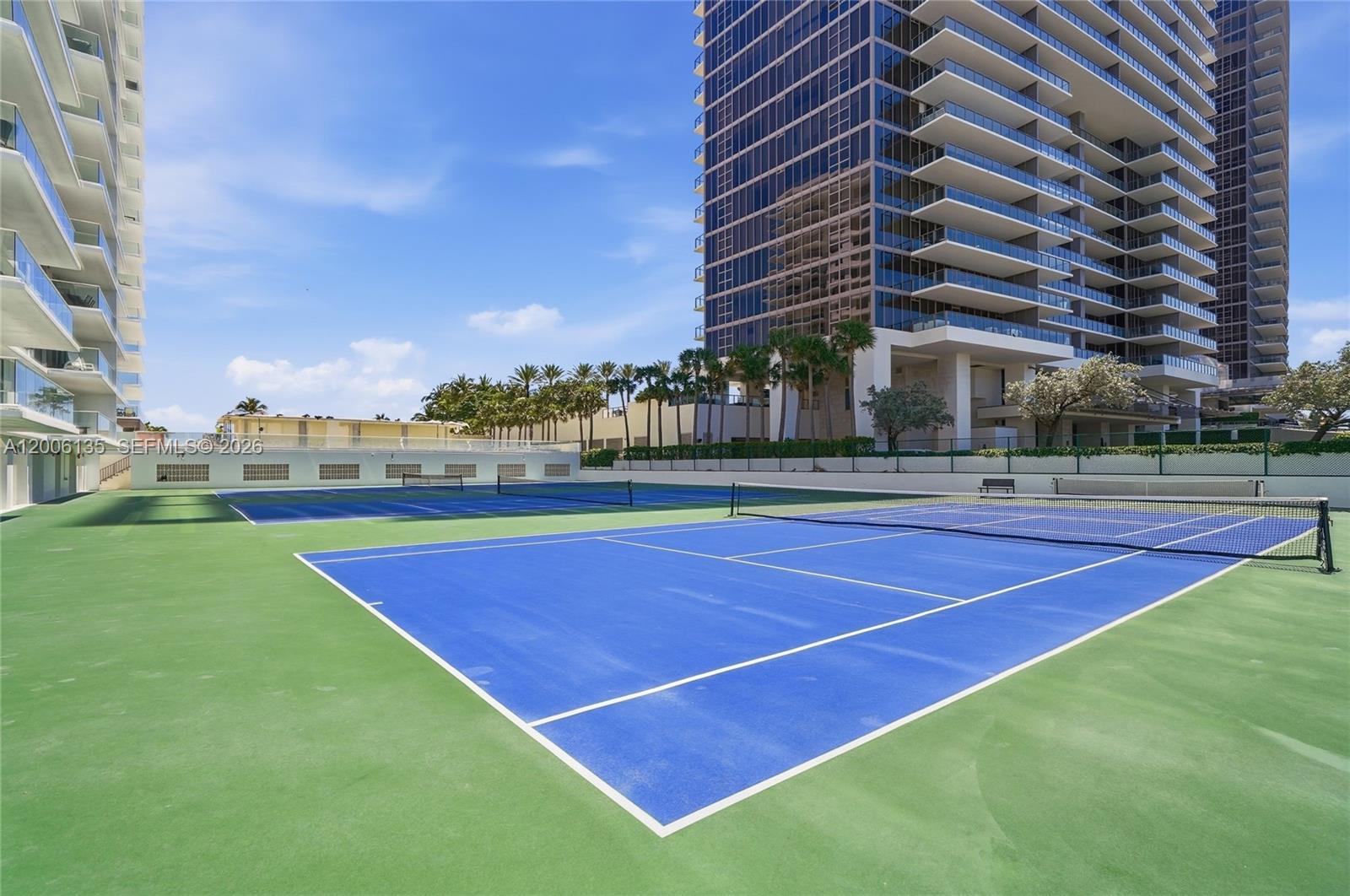 9801 Collins Avenue, Unit 14D Bal Harbour, FL 33154 - Photo 49 of 52 a tennis court with view of tall buildings
