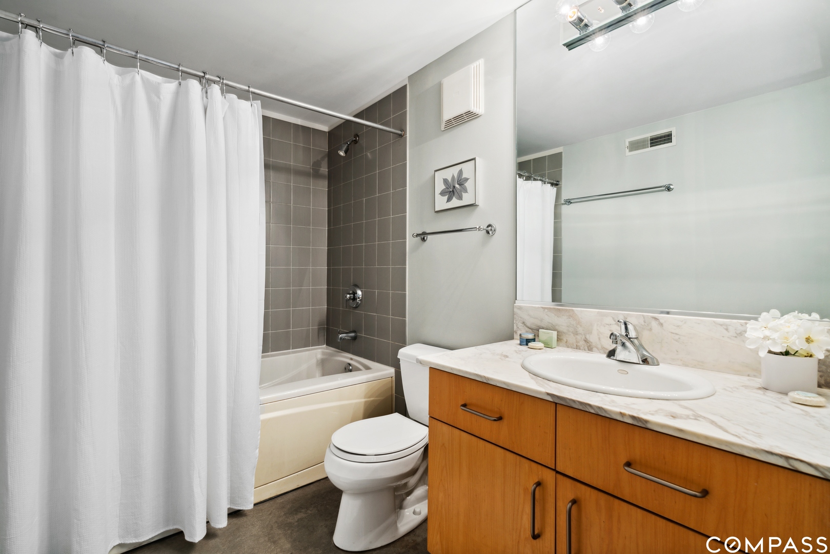 939 West Madison Street, Unit 306 Chicago, IL 60607 - Photo 13 of 15 a bathroom with a sink a toilet and shower