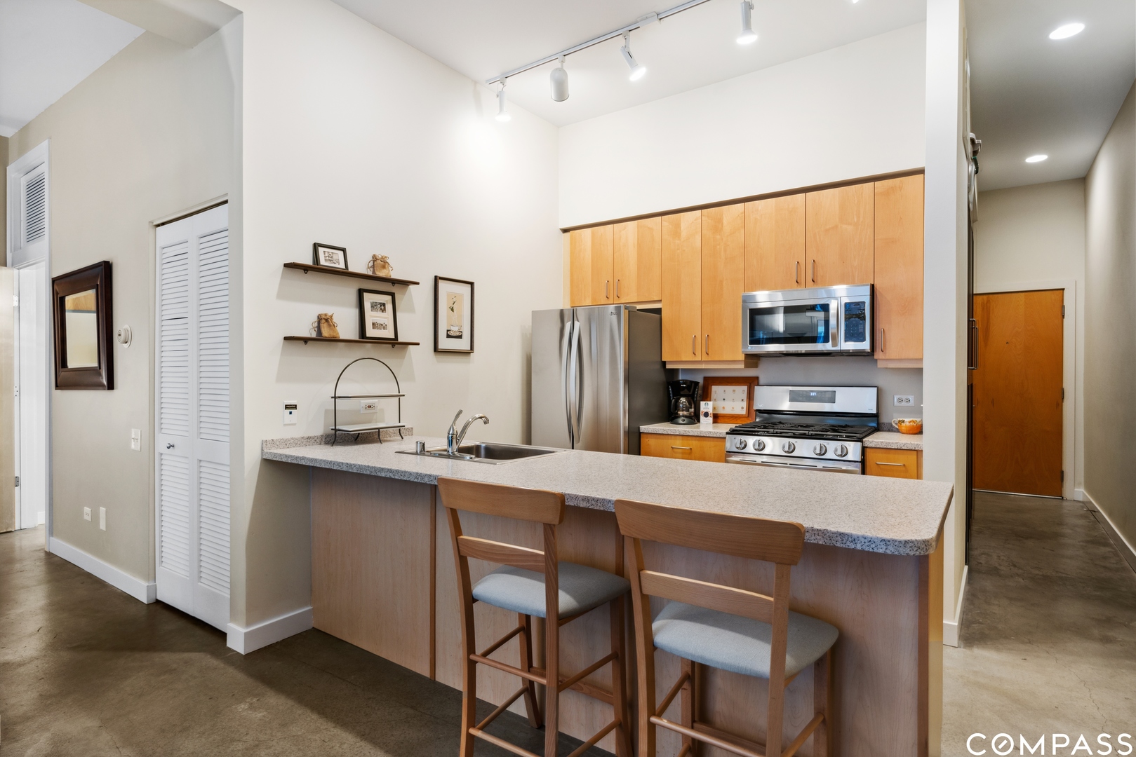 939 West Madison Street, Unit 306 Chicago, IL 60607 - Photo 7 of 15 a kitchen with stainless steel appliances a sink stove refrigerator and a refrigerator