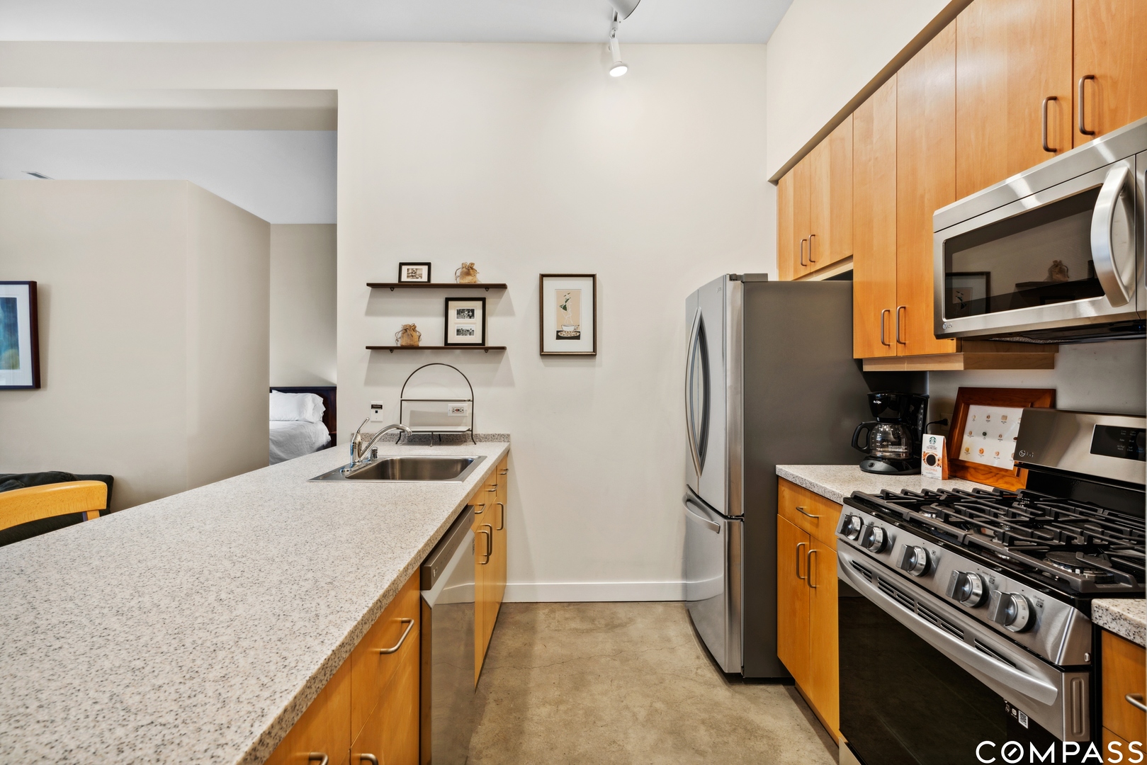 939 West Madison Street, Unit 306 Chicago, IL 60607 - Photo 8 of 15 a kitchen with stainless steel appliances granite countertop a stove refrigerator and microwave