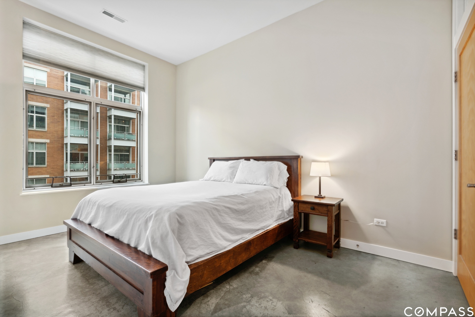 939 West Madison Street, Unit 306 Chicago, IL 60607 - Photo 10 of 15 a bed sitting in a bedroom next to a window