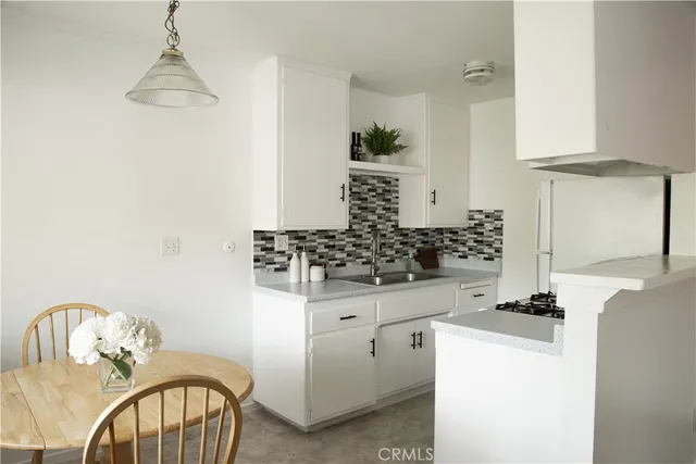 a kitchen with a refrigerator and a stove