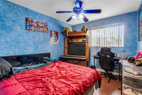 a bedroom with bed and a chandelier