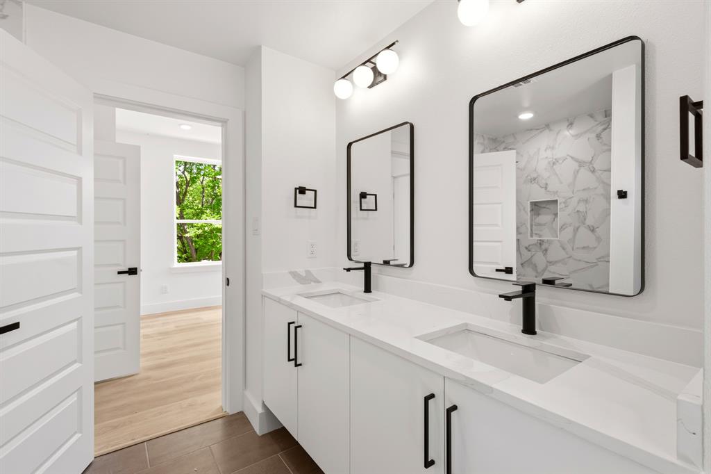 413 North Patton Avenue Dallas, TX 75203 - Photo 15 of 21 a bathroom with double vanity sink a mirror a glass door and shower