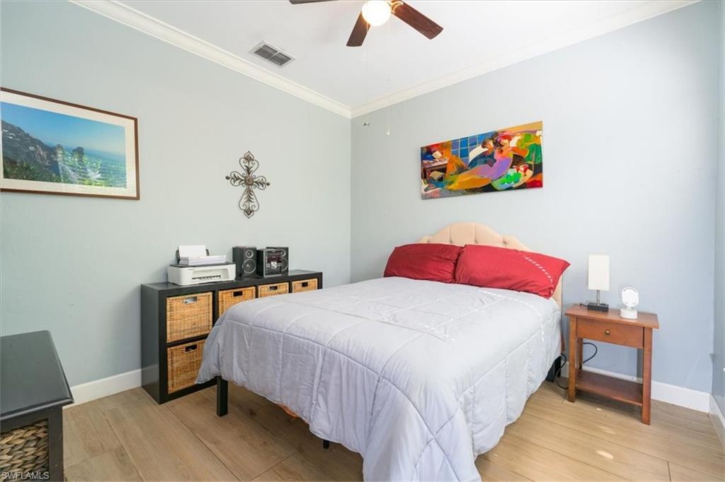 22855 Forest Ridge Drive Estero, FL 33928 - Photo 12 of 49 a bedroom with a bed and a desk