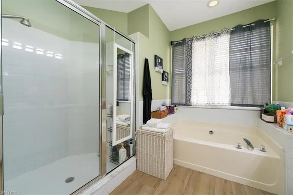 a bathroom with a tub a sink and mirrors