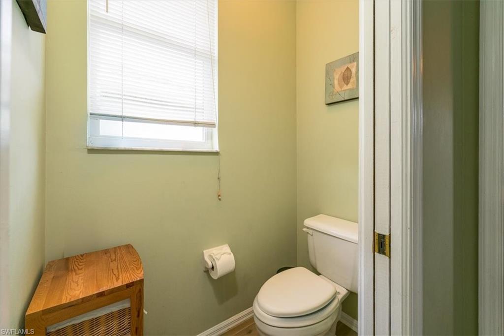 22855 Forest Ridge Drive Estero, FL 33928 - Photo 19 of 49 a white toilet sitting next to a bathroom sink