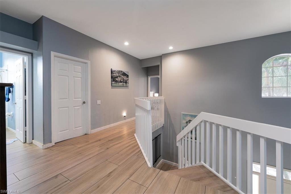 22855 Forest Ridge Drive Estero, FL 33928 - Photo 20 of 49 a view of a hallway with entryway and wooden floor