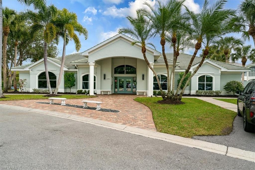 22855 Forest Ridge Drive Estero, FL 33928 - Photo 34 of 49 a front view of a house with a garden
