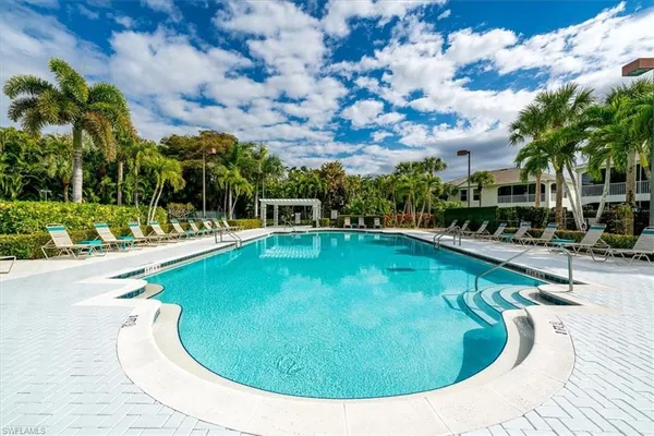 a building view with swimming pool and outdoor seating