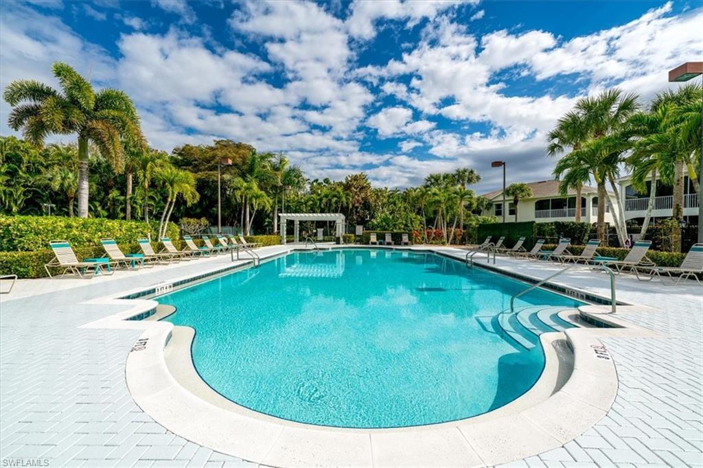 22855 Forest Ridge Drive Estero, FL 33928 - Photo 37 of 49 a swimming pool with outdoor seating and yard