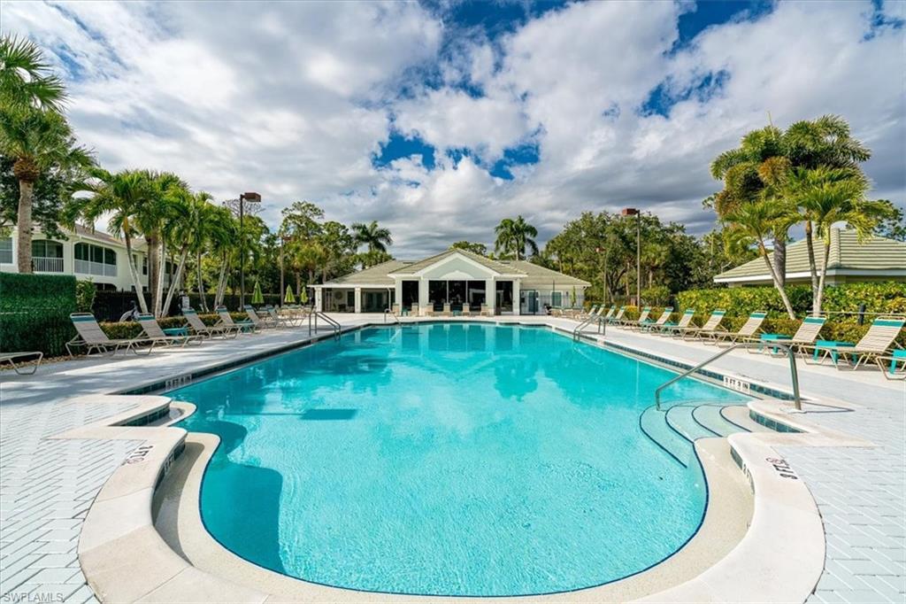 22855 Forest Ridge Drive Estero, FL 33928 - Photo 39 of 50 a swimming pool with outdoor seating and barbeque oven