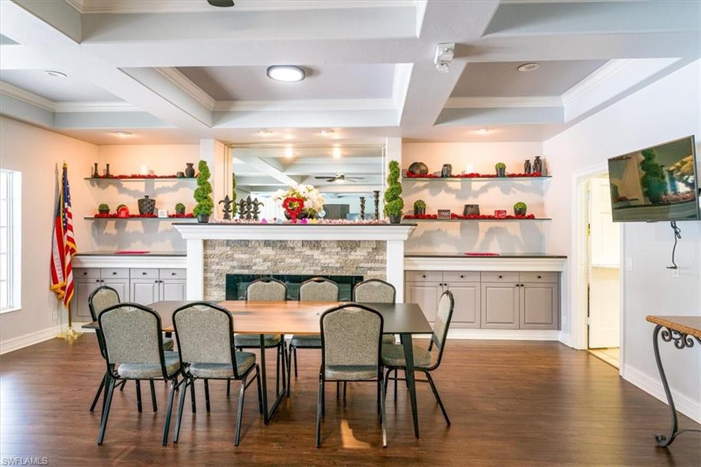 22855 Forest Ridge Drive Estero, FL 33928 - Photo 44 of 49 a dinning area with furniture fireplace and wooden floor