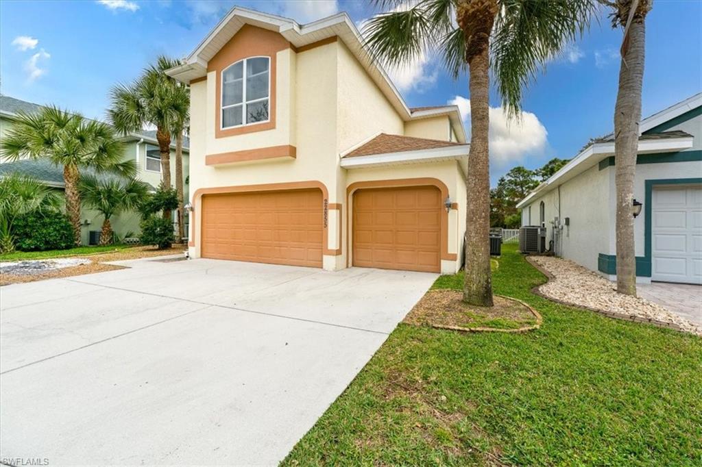 22855 Forest Ridge Drive Estero, FL 33928 - Photo 48 of 50 a front view of a house with a yard and garage