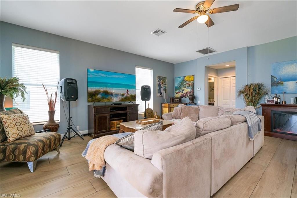 22855 Forest Ridge Drive Estero, FL 33928 - Photo 4 of 49 a living room with furniture and a flat screen tv