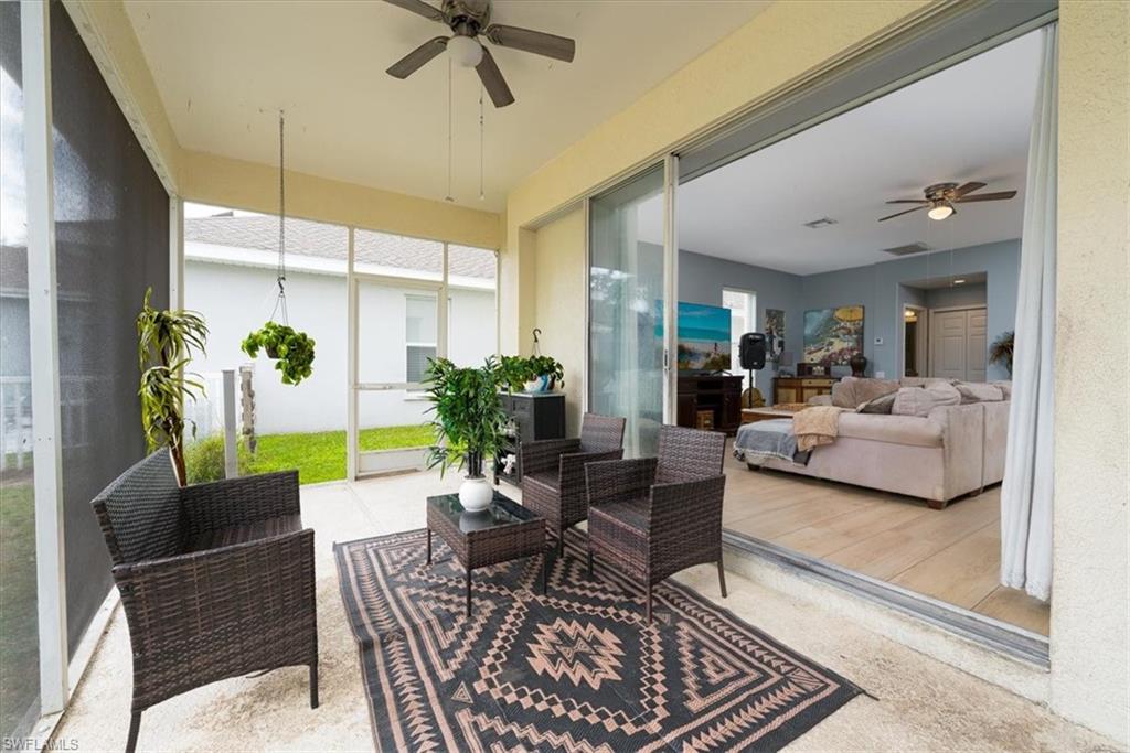 22855 Forest Ridge Drive Estero, FL 33928 - Photo 5 of 49 a living room with furniture and a potted plant