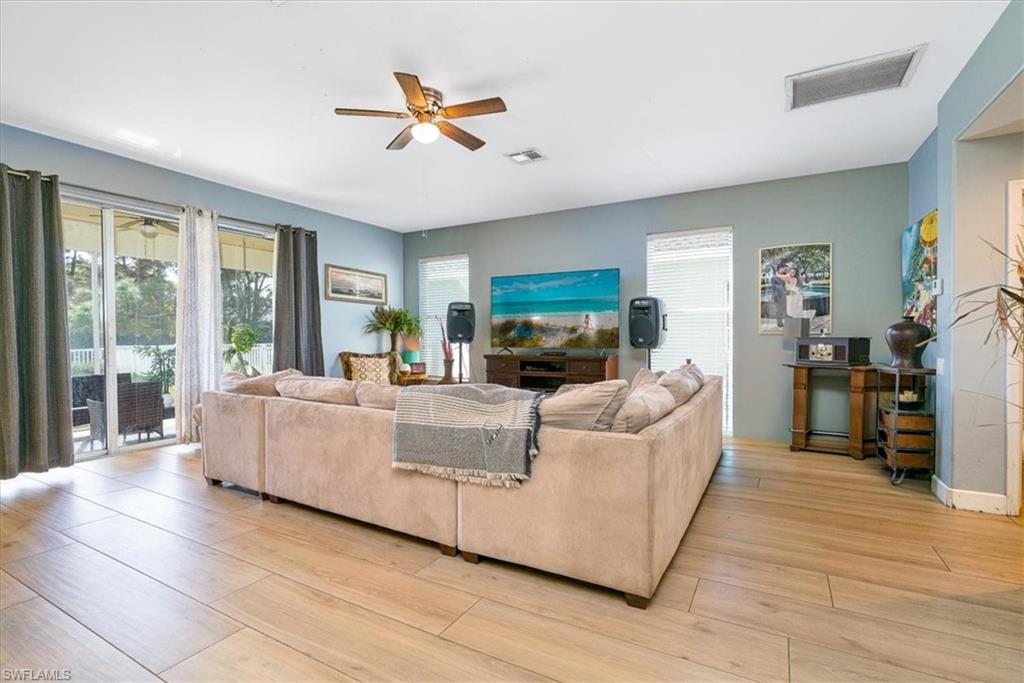 22855 Forest Ridge Drive Estero, FL 33928 - Photo 49 of 49 a living room with furniture and a fireplace