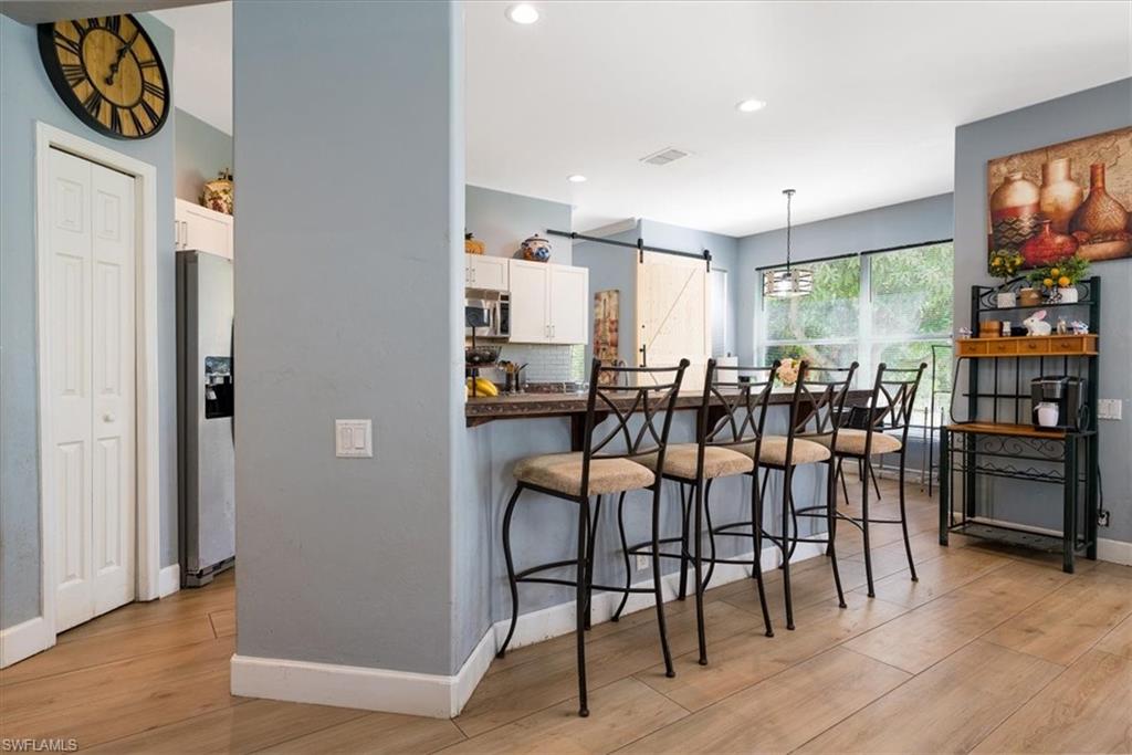22855 Forest Ridge Drive Estero, FL 33928 - Photo 6 of 49 a view of a dining room with furniture and wooden floor