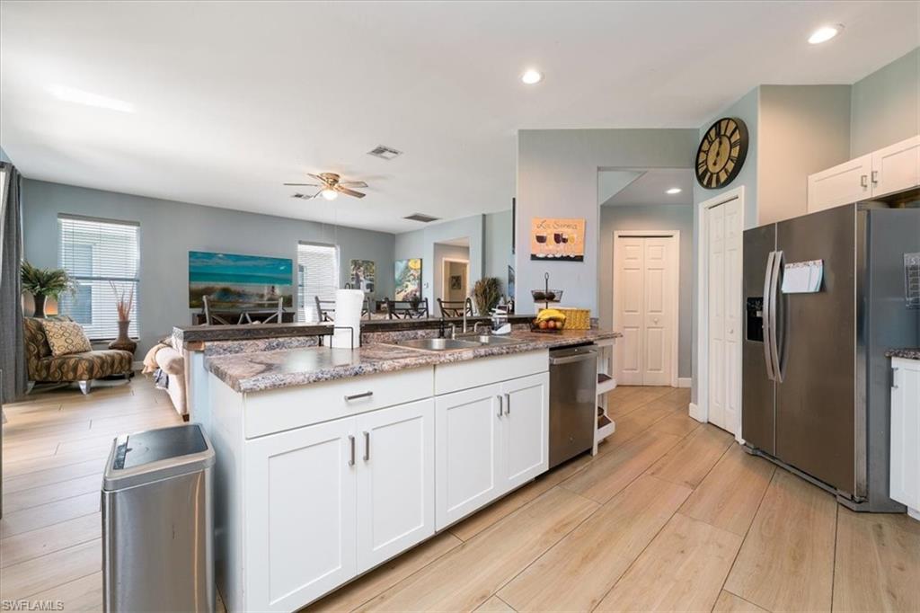 22855 Forest Ridge Drive Estero, FL 33928 - Photo 8 of 49 a kitchen with a sink cabinets and wooden floor