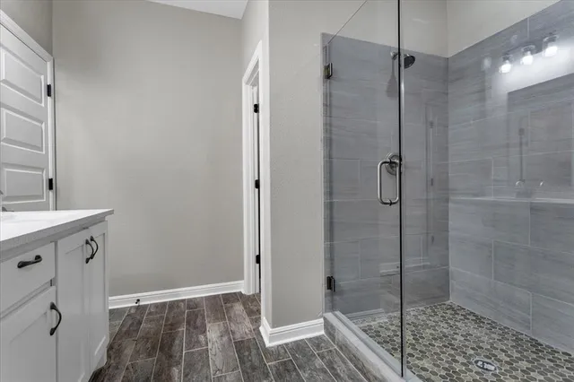 a bathroom with a shower and a sink