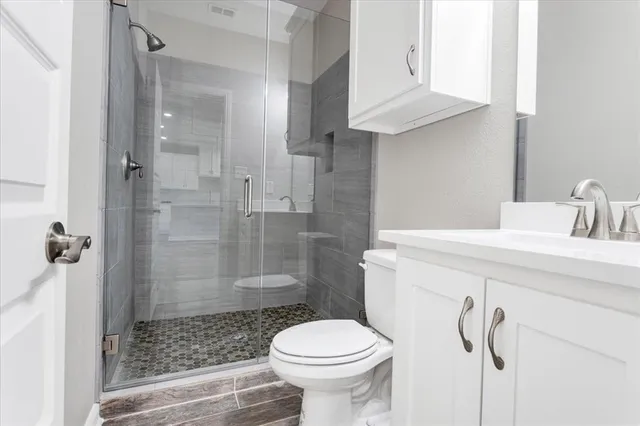 a bathroom with a sink toilet and shower