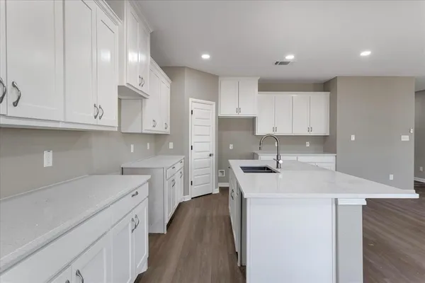 a kitchen with a sink stove and cabinets
