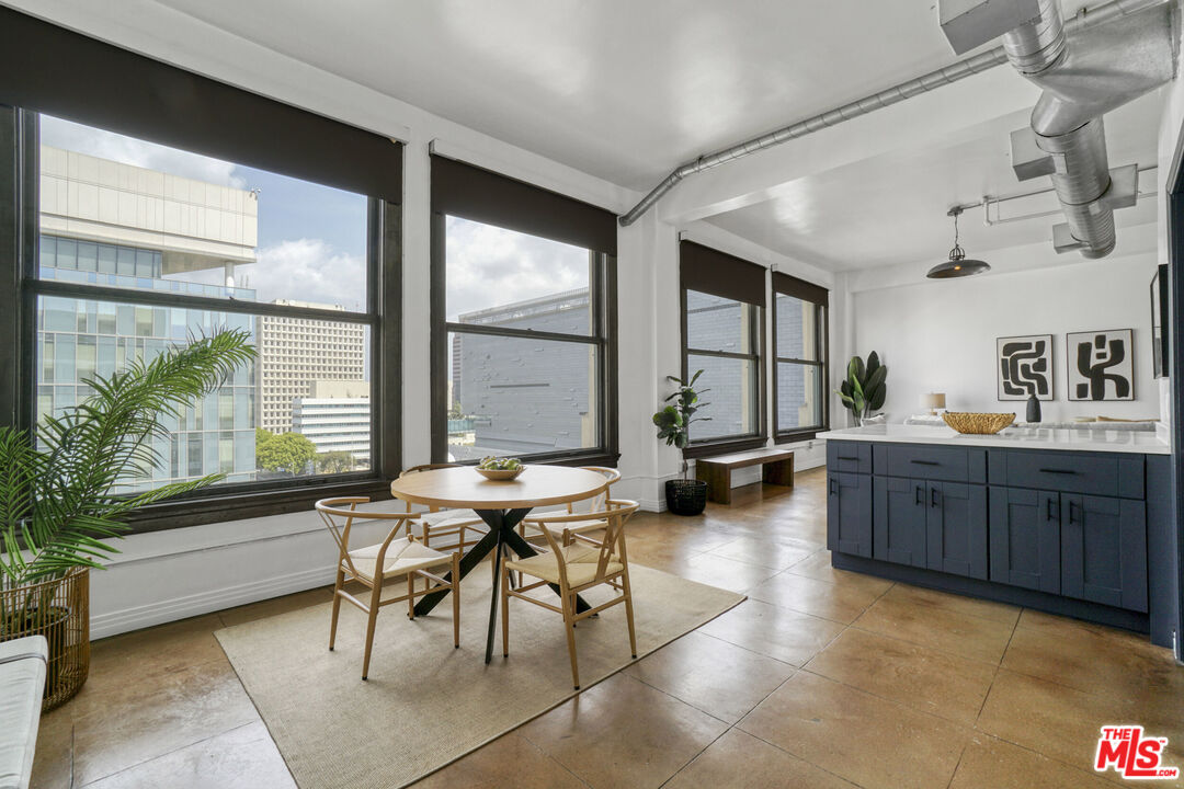 108 West 2nd Street, Unit 915 Los Angeles, CA 90012 - Photo 11 of 27 a living room with furniture and a large window