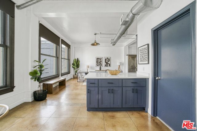 a spacious bathroom with a tub sink and glass door