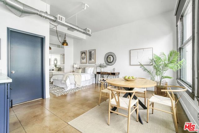 a view of a dining room with furniture and a potted plant