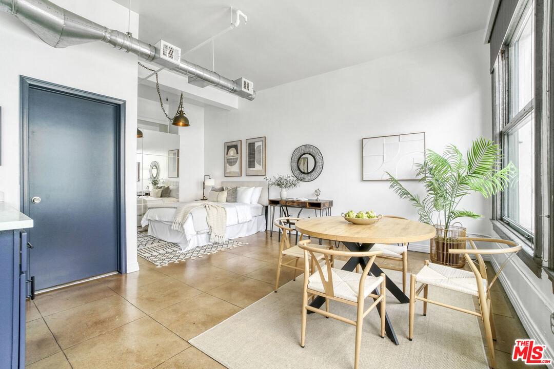 108 West 2nd Street, Unit 915 Los Angeles, CA 90012 - Photo 14 of 27 a view of a dining room with furniture and a potted plant