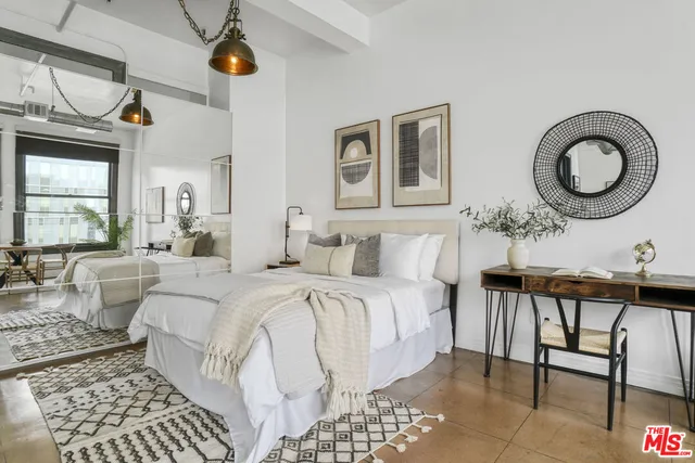 a living room with a bed furniture and a window