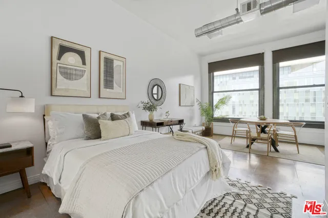 a bedroom with bed and a large window