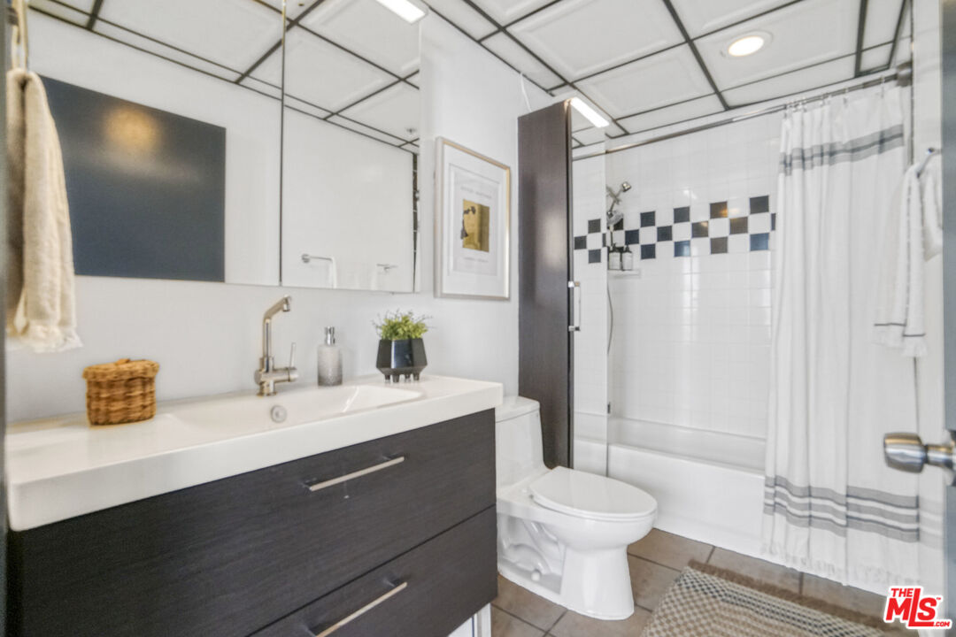 108 West 2nd Street, Unit 915 Los Angeles, CA 90012 - Photo 19 of 27 a bathroom with a sink a toilet and shower