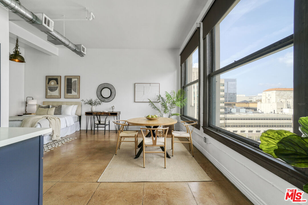 108 West 2nd Street, Unit 915 Los Angeles, CA 90012 - Photo 9 of 27 a living room with furniture and a large window