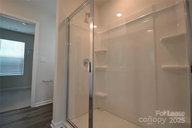 a bathroom with a toilet and a shower